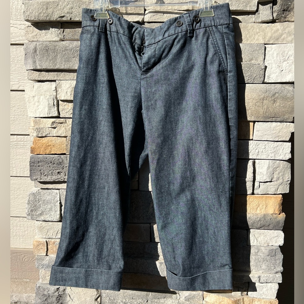 Hit just below the knee.  Black denim stretch material. Trouser style.